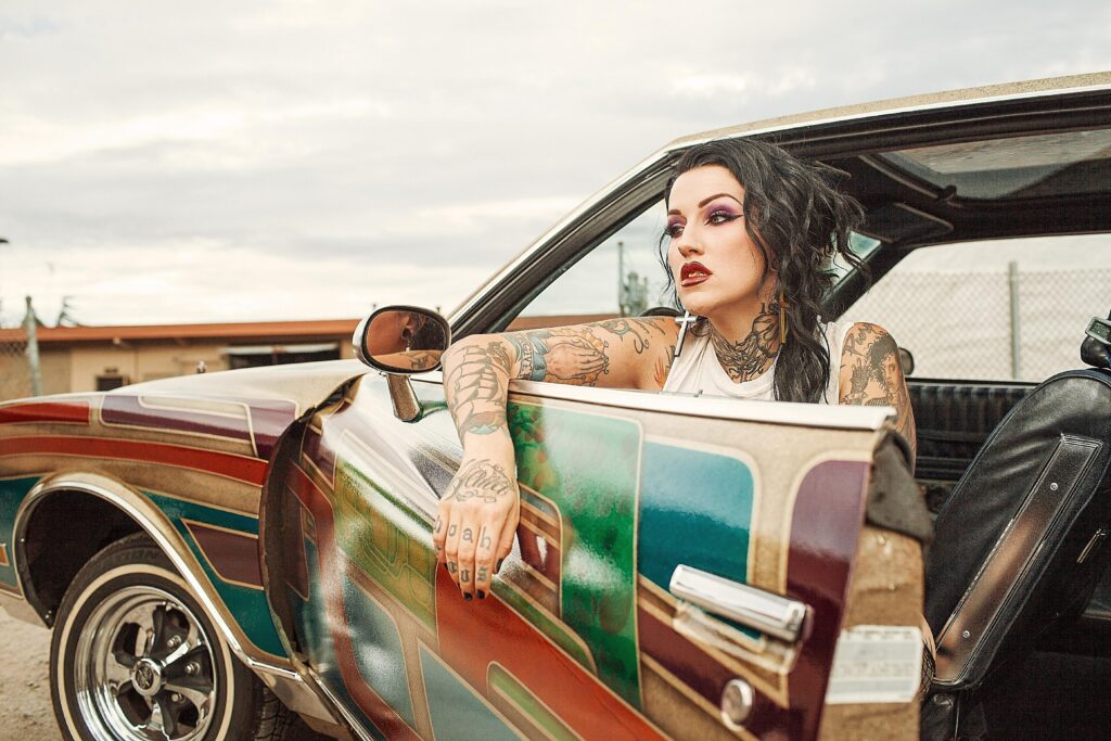 A group of diverse individuals showcasing their tattoos and embracing tattoo culture.